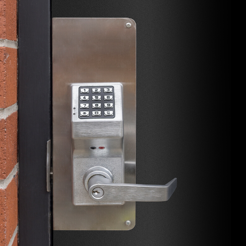 A stainless-steel keypad lock for an exterior door to an apartment building.